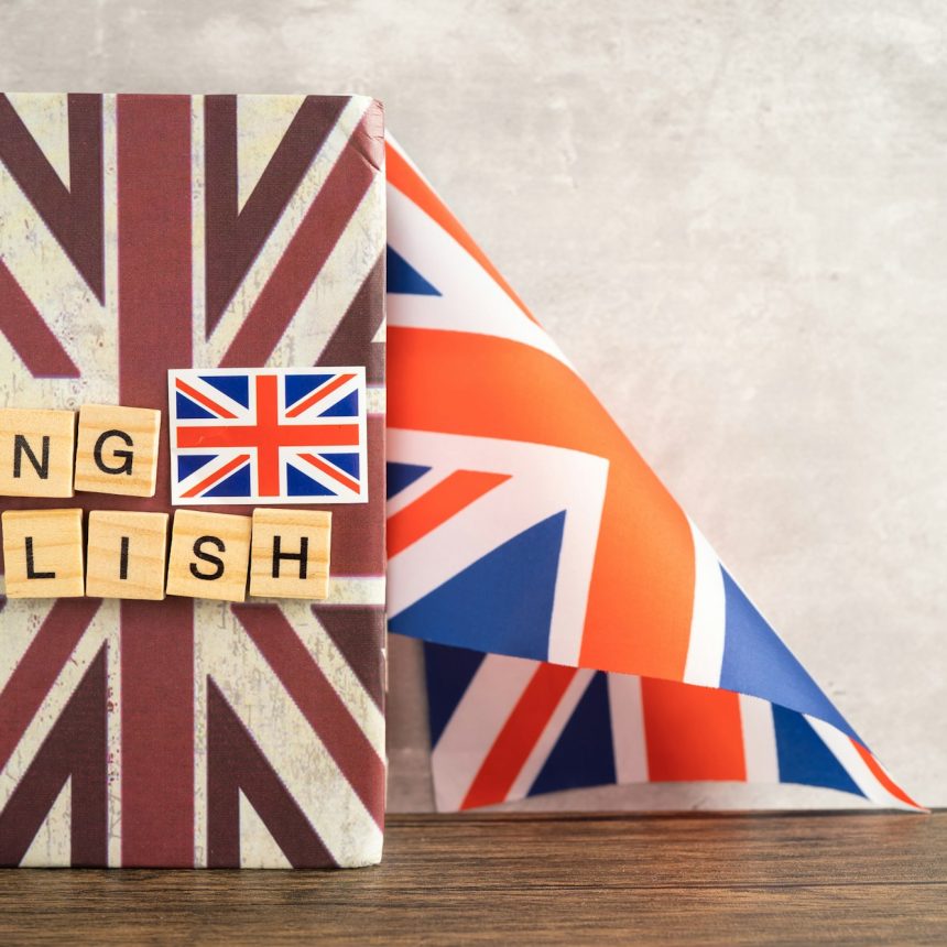 Word English on book with United Kingdom flag, learning English language courses concept.